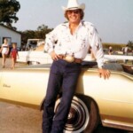 Jon Gilliam posing with his Cadillac.