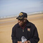Ormand collecting sand on Omaha Beach during his June 2013 visit to Nromandy, France.
